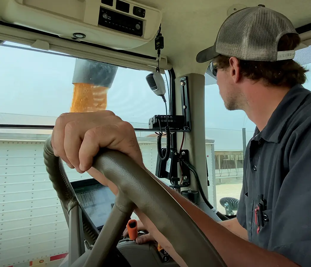 Operator's View of Unloading a Right Side Auger Grain Cart into a Semi