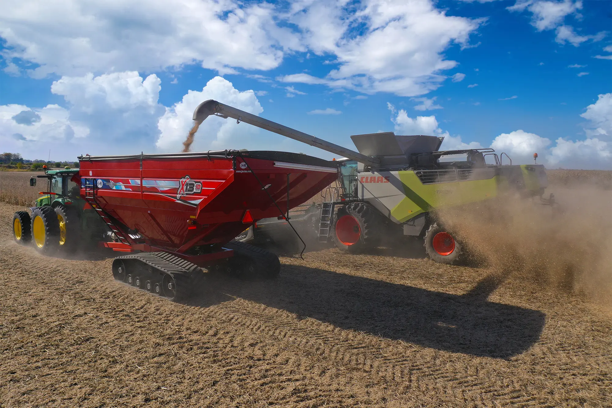 1312 red grain cart being filled on the go