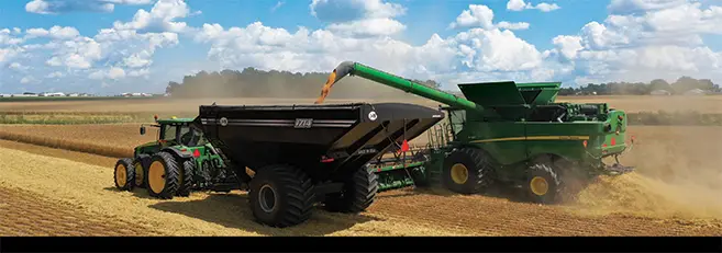 A 1114 being filled by a combine