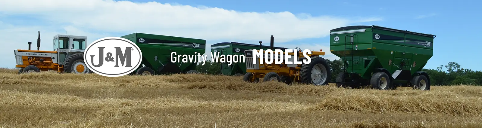 a couple of gravity wagons pulled through a wheat field