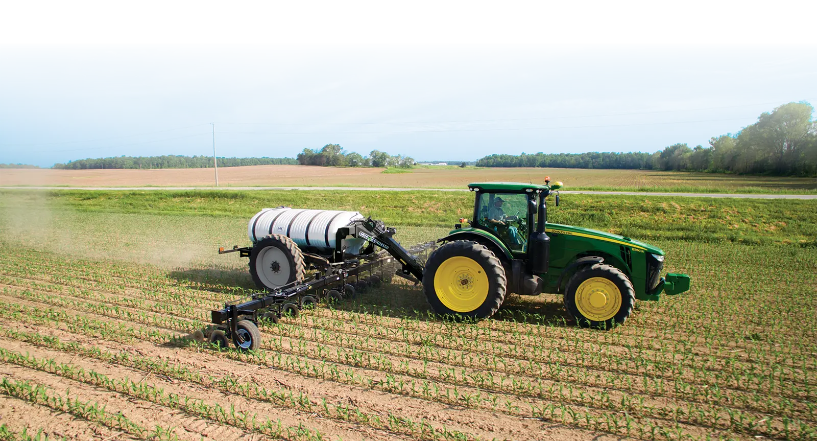 a black 5016 nitrogen applicator being pulled in a field