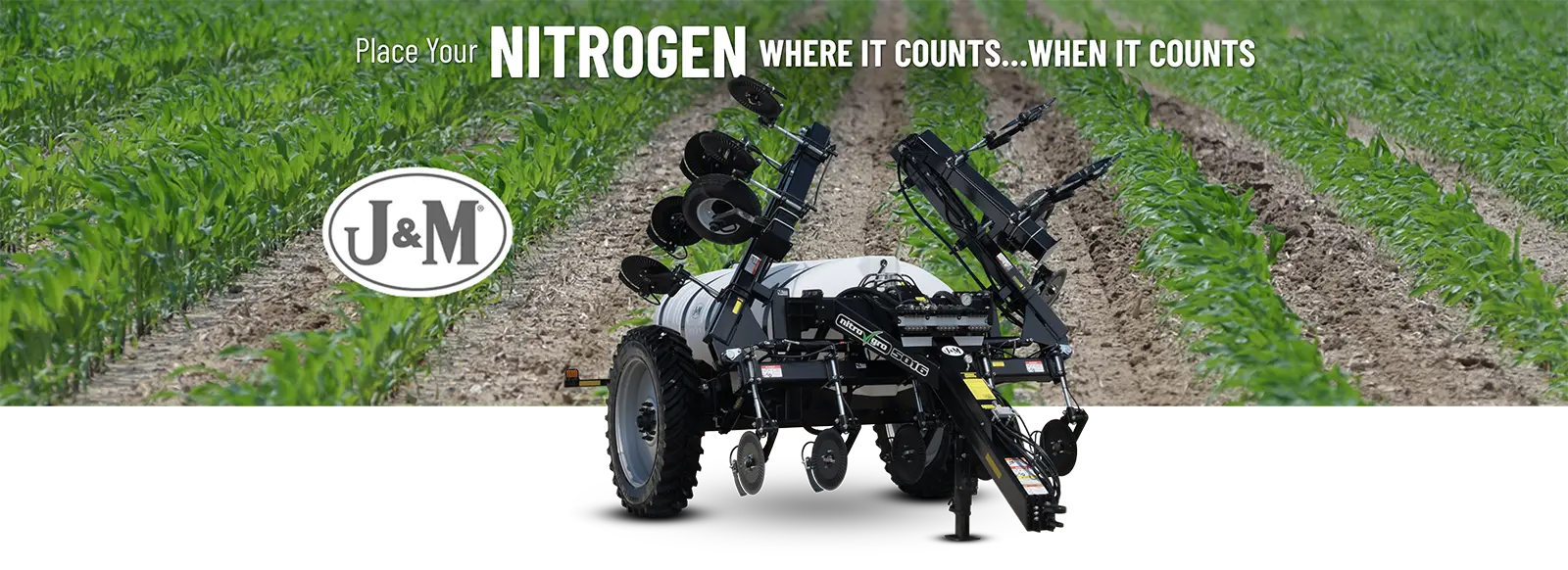 a 5016 sitting in front of a young corn field