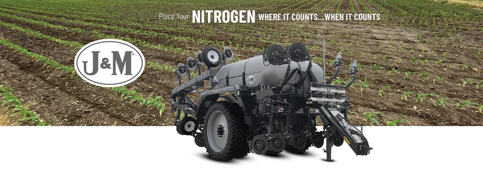 a 6026 sitting in front of a young corn field