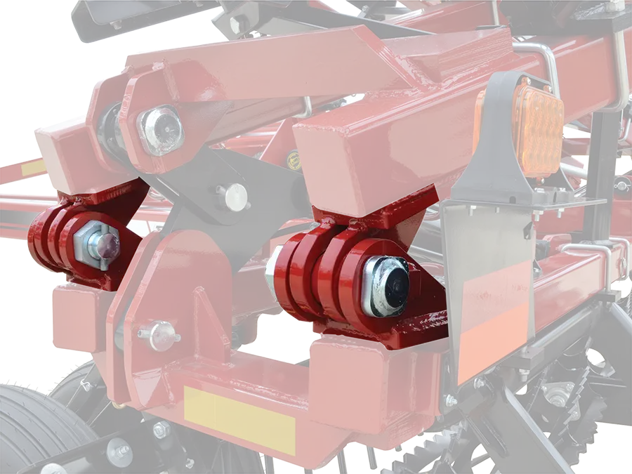 a close up of the hinges of a 3-section soil conditioner showing the grease fittings and heavy duty construction