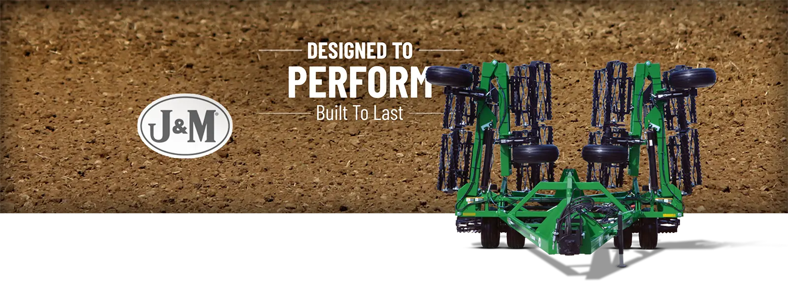 a green folded 5-section soil conditioner sitting in the lot in front of a field.