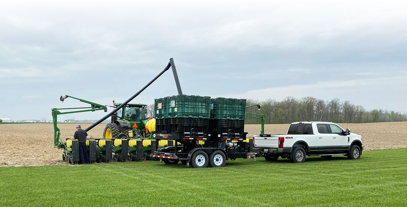 a 451 pro box next to a field filling a row box planter