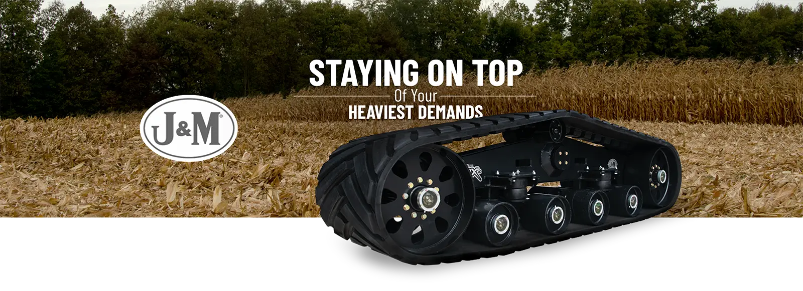High-flotation JM track system for agricultural grain carts cutout and sitting in front of a field
