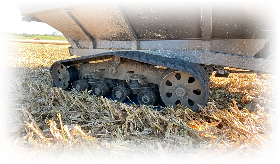 showing a close up of tracks on a grain cart with a faded background.