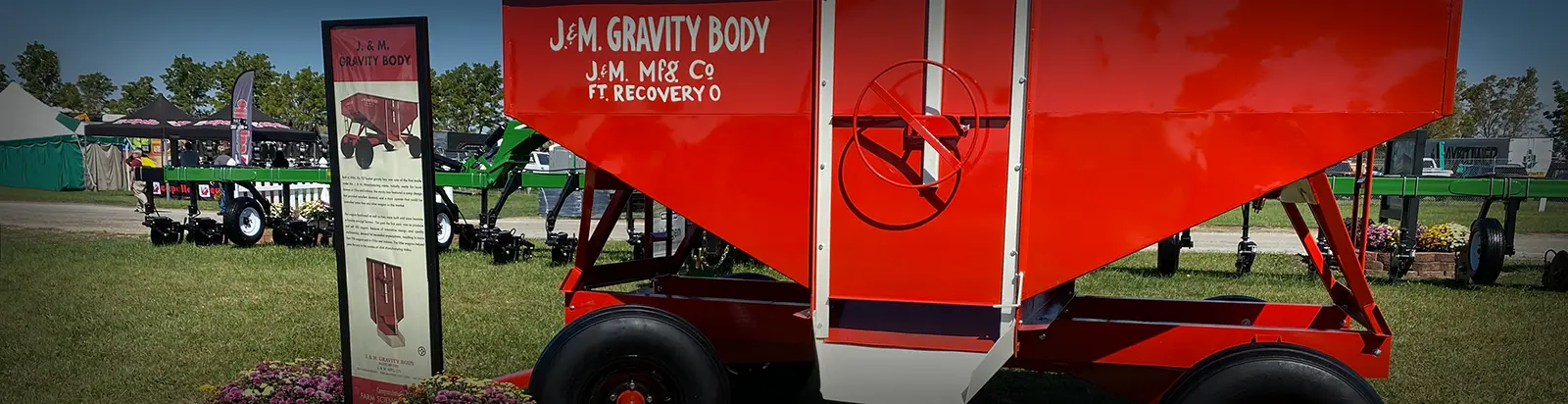 an old style gravity wagon that was one of the originals at J&M sitting on our lot at a trade show.